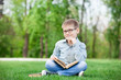© Masson - Happy young boy with a books