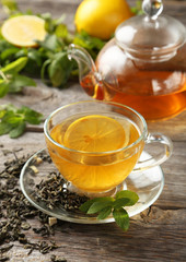 Cup with green tea on wooden background