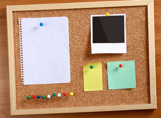 Cork message board with various paper notes