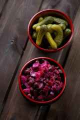 Poster - Wooden bowls with russian vinegret and pickled cucumbers