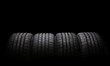 four automobile rubber tires isolated on black background