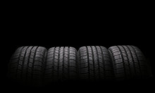 Four Automobile Rubber Tires Isolated On Black Background