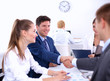 © lenets_tan - Business people shaking hands, finishing up a meeting, in office