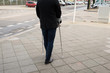 © Andrey Popov - Man Walking On Street Using Crutches