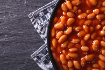 Poster - beans in tomato on a plate close-up. horizontal top view 
