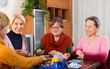 Pensioners playing board game