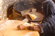 Old Arab woman prepares bread