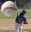 © justasc - Closeup of a baseball being pitched.