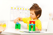 Boy putting colorful cubes in construction game