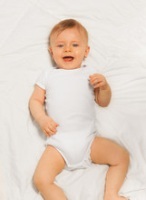 Laughing Small Baby Wearing White Bodysuit