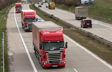 Red trucks driving on highway