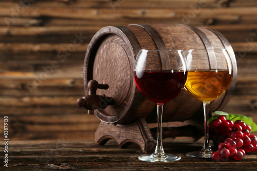 czerwone-i-biale-wino-w-przezroczystych-kieliszkach-na-tle-nieduzej-beczki
