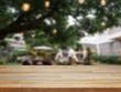 Empty wooden table and blurred outdoor cafe background