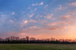 Beautiful sunset. Spring landscape with trees, blue sky and clou