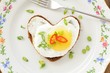 © alexeyborodin - Fried egg heart rye sandwich with scallion, chili and fork on wh