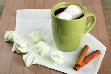 Wall Mural - A cup of hot chocolate with marshmallows on the wooden background