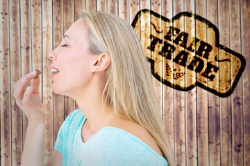 Poster - Composite image of pretty blonde eating a chocolate 