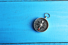 Compass On Blue Wooden Background