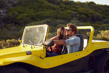 Wall Mural - Affectionate young couple on a roadtrip