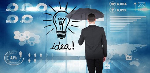 Poster - Composite image of businessman sheltering under black umbrella