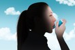 © WavebreakMediaMicro - Composite image of pretty blonde using an asthma inhaler