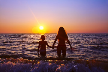 Wall Mural - mother and daughter at sunset