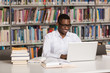© Jale Ibrak - Happy African Male Student With Laptop In Library