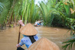 Vietnamese woman paddling in the Mekong River, Vietnam