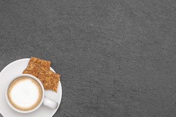 delicious coffee and sweets on anthracite background