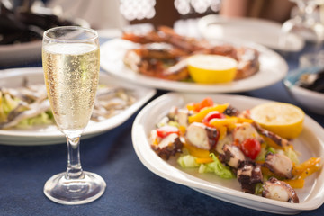 Italian cuisine. Glass of prosecco and variety of seafood