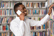 © Jale Ibrak - Handsome College Student Using Mobile Phone In Library