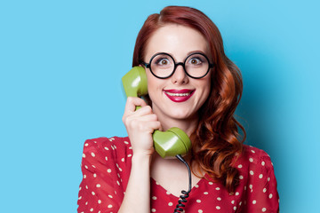 Wall Mural - girl in red dress with green dial phone