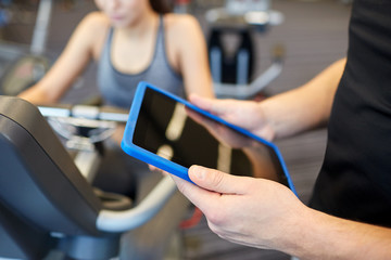 Sticker - close up of trainer hands with tablet pc in gym