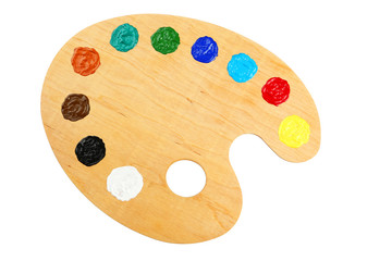 Wooden art palette with paints isolated on white