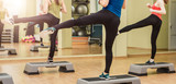 Group of women making step aerobics from the backside