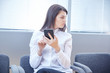 © photoniko - business woman with mobile phone sits in the office