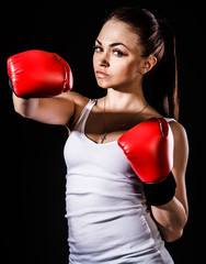 Beautiful young woman in a red boxing gloves