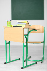 Sticker - Wooden desk with stationery and chair in class 