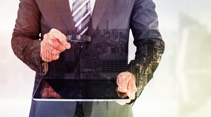 Poster - Composite image of businessman looking at tablet 