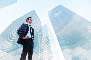 Poster - Composite image of happy businessman with hands on hips