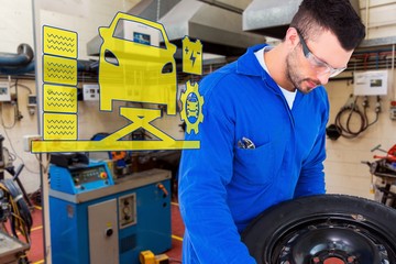 Poster - Composite image of mechanic working on tire