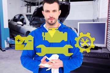 Poster - Composite image of mechanic wiping hands with cloth