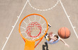 © kolotype - Young Man Making Lay Up Shot on Basketball Net