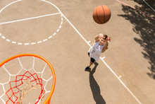 Above View Of Man Tossing Basketball Into Hoop
