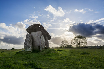 Wall Mural - trethevy quoit, cornwall, uk at sunset with blue sky and clouds