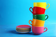 Colorful cups on blue wooden background