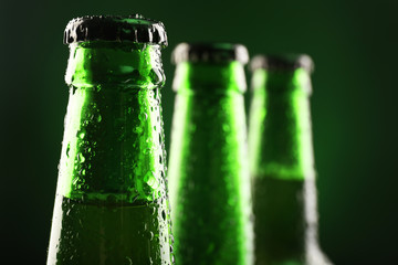 Poster - Glass bottles of beer on dark background