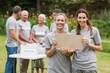 © WavebreakMediaMicro - Happy volunteer family holding donation boxes