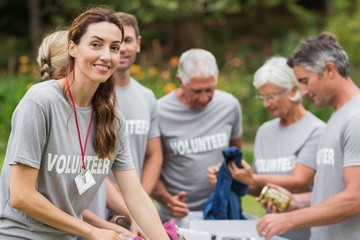 Happy volunteer looking at donation box 