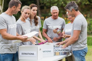 Happy volunteer looking at donation box 